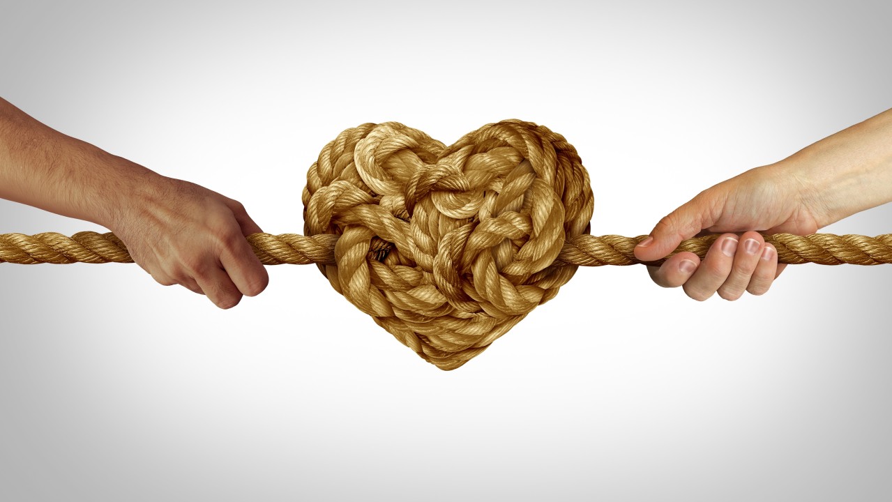 Tug or war, with a rope and a heart not in the middle